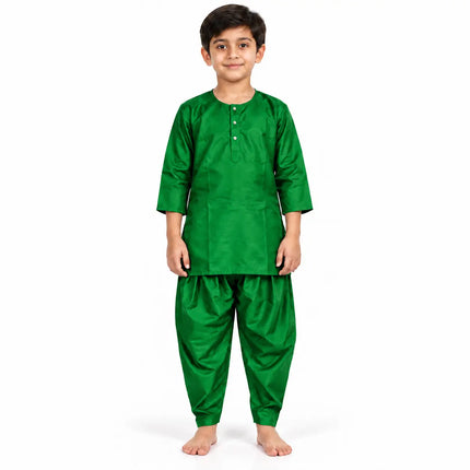Boy wearing emerald green kurta and matching dhoti-style bottoms