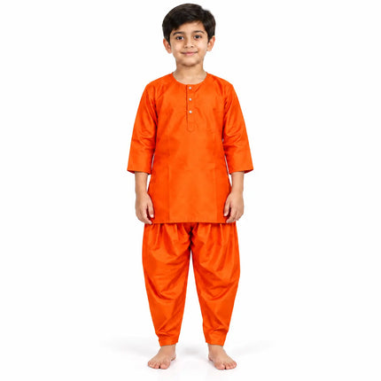 Boy wearing orange kurta and matching dhoti-style bottoms