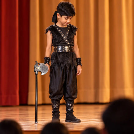 Dark theatrical costume styling with Pharsa on a school stage