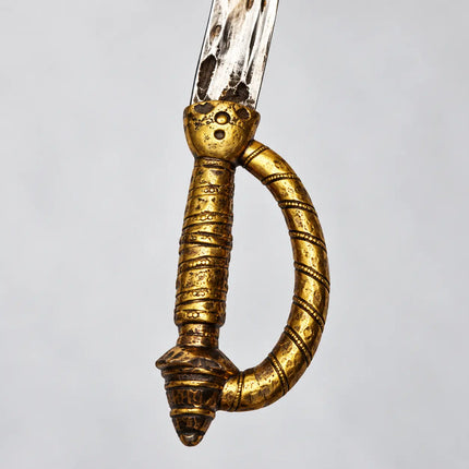 Close-up of ornate gold-tone loop handle
