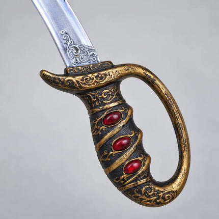 Close-up of ornate sword handle with three red oval accents